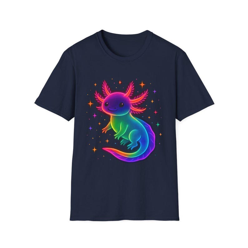 May include: A navy blue t-shirt with a colourful illustration of an axolotl. The axolotl is rendered in rainbow colours, smiling, and surrounded by stars. The design is printed on a classic crew neck tee.