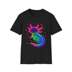 May include: Black t-shirt with a neon axolotl design. The axolotl is rendered in bright colours, including pink, purple, green, and blue, with a rainbow tail. The design incorporates stars, creating a whimsical and eye-catching graphic.