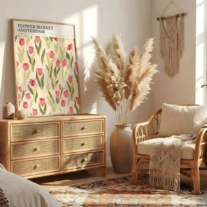 Bright boho living space with rattan furniture and a large Amsterdam flower market print in a light wood frame.