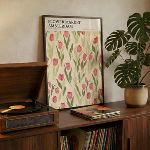 Retro style Amsterdam flower market botanical print resting on a mid-century wooden console with a record player.