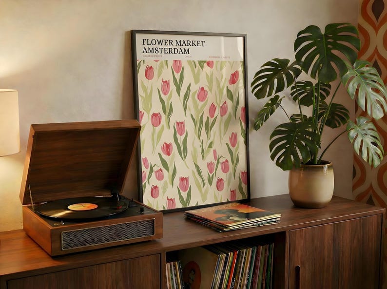 Retro style Amsterdam flower market botanical print resting on a mid-century wooden console with a record player.