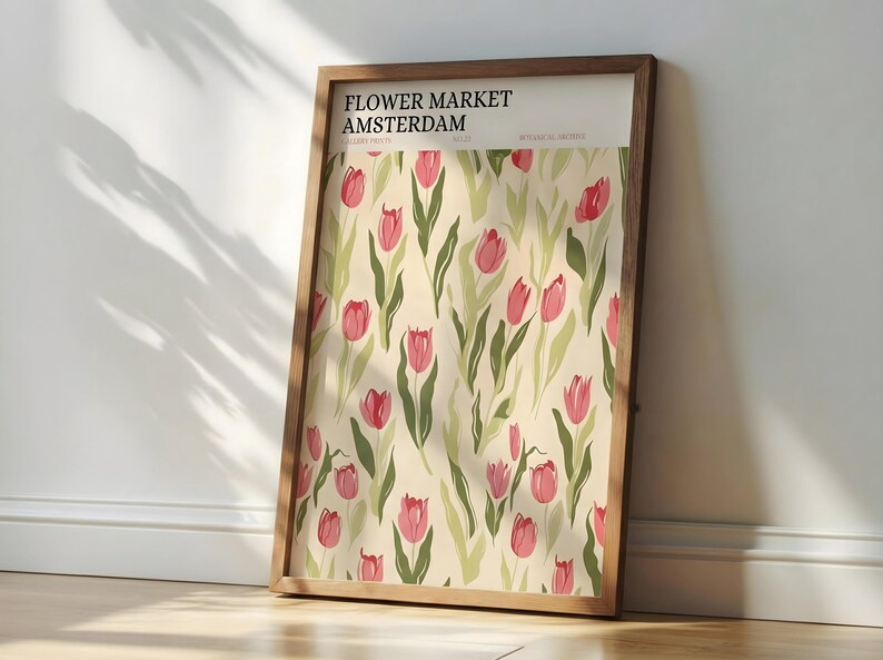 Rustic kitchen decor featuring a framed Amsterdam pastel floral exhibition poster on a wooden counter with copper pots.