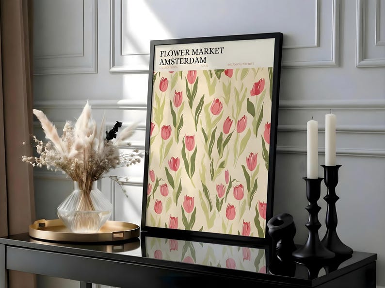 Elegant room decor featuring a framed pastel floral Amsterdam print on a black sideboard with dried flowers.