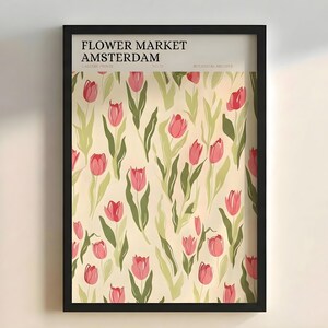 Flat lay view of the framed pastel botanical Amsterdam tulip poster against a plain light background.