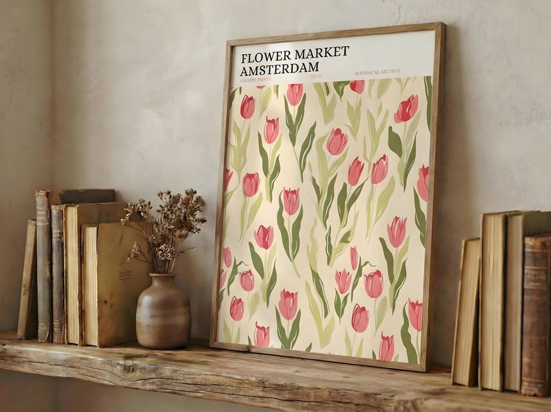 Rustic wooden shelf styled with vintage books and a framed detailed Amsterdam pastel pink tulip poster.