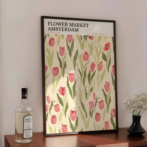 Boho style shelf decor with a retro Amsterdam flower market tulip poster leaned next to glass vases and botanicals.
