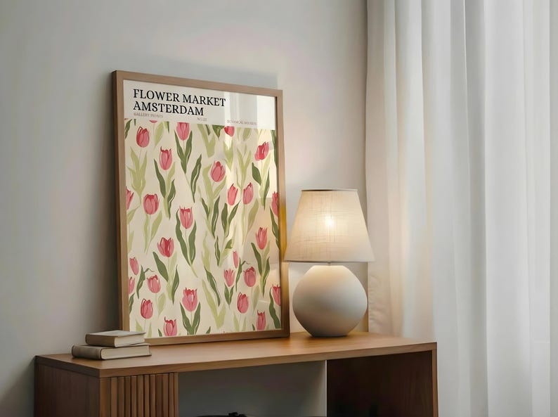 Cozy room corner with a wooden side table, a warm lamp, and a retro Amsterdam flower market print leaning against the wall.