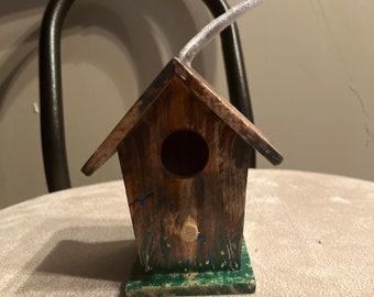 Tiny painted wooden birdhouse