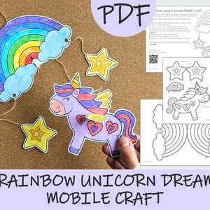 May include: A Rainbow Unicorn Dream Mobile Craft, with a rainbow, clouds, stars, and a unicorn. The image includes a PDF with instructions and a QR code. The mobile is made of paper and is held by a hand.