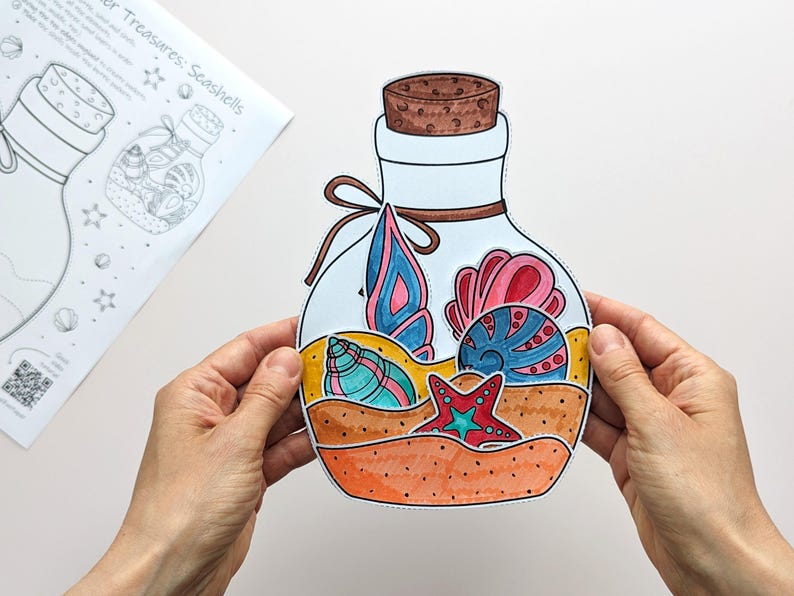 May include: A colorful paper cutout of a bottle filled with seashells. The bottle has a cork stopper and a brown ribbon tied around the neck. Inside the bottle are various seashells in shades of blue, pink, and yellow. The words "Summer Treasures: Seashells" are on a paper in the background.
