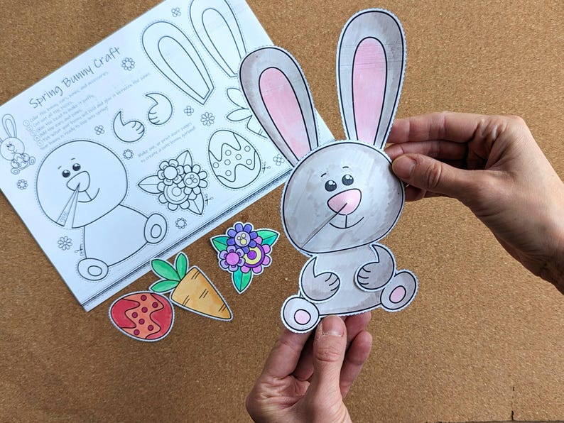 May include: A spring bunny craft kit with a gray and pink bunny cutout, along with other colorful cutouts of a carrot, flower, and egg. The kit includes a sheet with instructions and bunny parts.