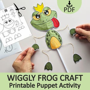 May include: A paper craft kit for a frog puppet featuring a green frog head with a yellow crown and red tongue, a green and yellow body, and separate limbs attached with twine. Includes printed instruction sheets labeled Wiggle Frog Puppet Craft.