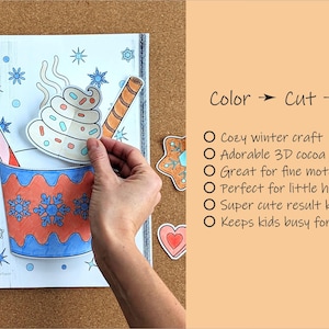 Peut inclure: Un projet d'artisanat sur le th&egrave;me de l'hiver avec un motif de tasse de cacao. L'image montre une main assemblant une d&eacute;coupe en papier color&eacute;e d'une tasse de cacao avec des flocons de neige, une canne en bonbon et de la cr&egrave;me fouett&eacute;e. Le texte indique "Color -> Cut -> Glue."