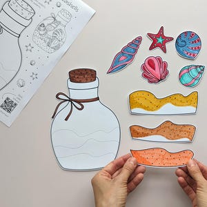 May include: A craft project featuring a large white bottle outline with a cork and bow, and a sheet with a bottle illustration and the word "seashells". Colorful seashell cutouts and sand-like shapes are also present.