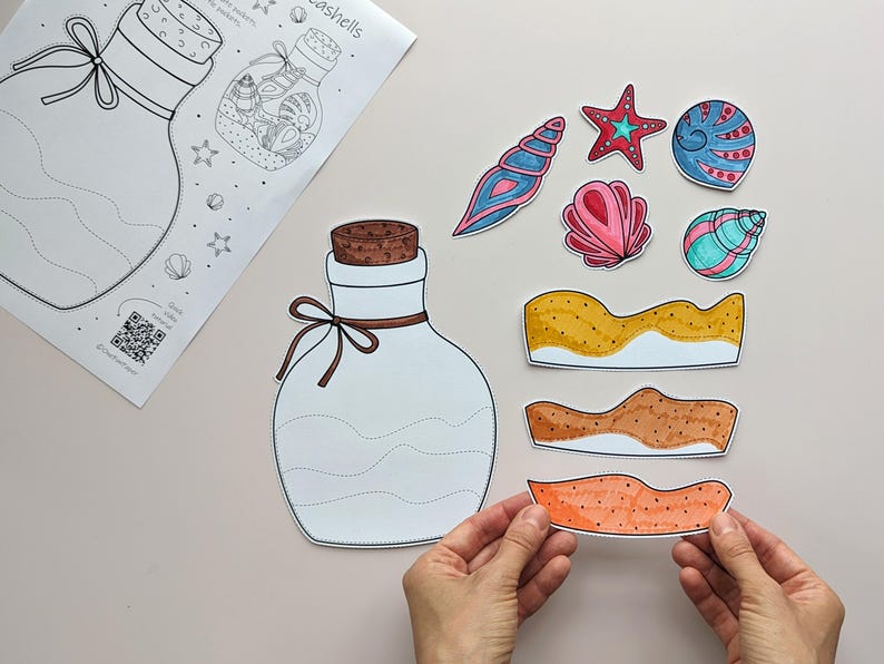 May include: A craft project featuring a large white bottle outline with a cork and bow, and a sheet with a bottle illustration and the word "seashells". Colorful seashell cutouts and sand-like shapes are also present.