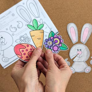 May include: A craft project with a spring bunny theme. The image shows a partially assembled bunny, a carrot, a decorated egg, and flowers. The text "Spring Bunny Craft" is visible on a sheet of paper with bunny outlines.