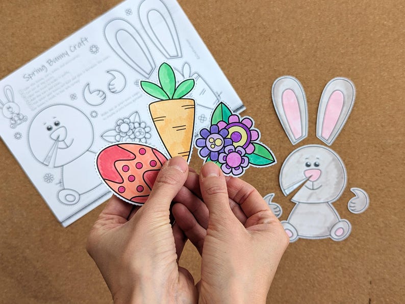 May include: A craft project with a spring bunny theme. The image shows a partially assembled bunny, a carrot, a decorated egg, and flowers. The text "Spring Bunny Craft" is visible on a sheet of paper with bunny outlines.