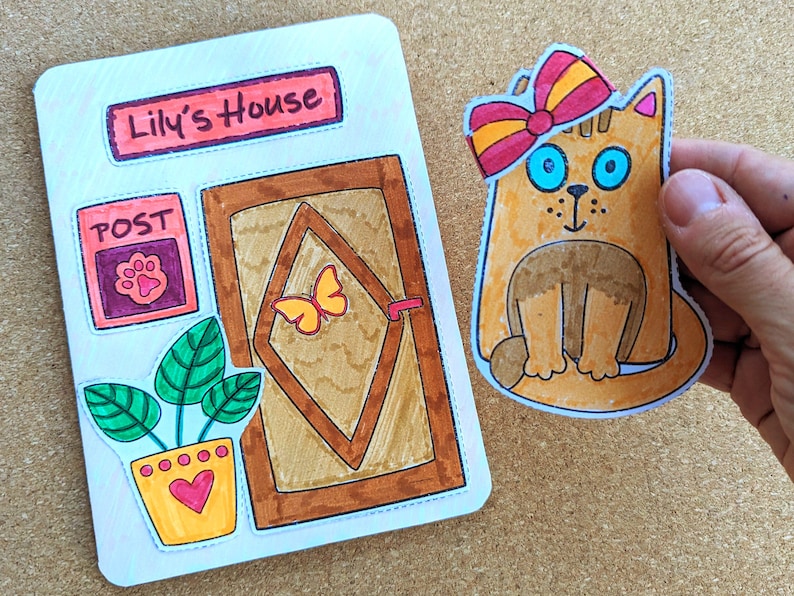 May include: Hand-drawn illustration of a cat with a bow and a house with a door, a post box, and a potted plant. The house sign reads "Lily's House". The cat is orange with blue eyes. The bow is red and yellow.