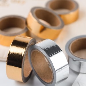 NUR für Gästebücher & -alben Dekoratives Washi Tape in Golden/Silber kann NICHT separat erworben werden. 4,5 cm lang und 15 cm schwer. Breite