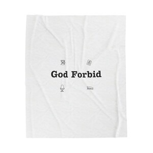 May include: White blanket with the text "God Forbid" in black, along with small black illustrations of a coffee cup, document, chair, and stapler. The blanket has a slightly wrinkled texture.