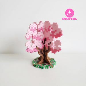 May include: A pixelated cherry blossom tree sculpture. The tree features a brown trunk, a green base with small flowers, and pink and light pink blossoms. The word "DIGITAL" is in pink text.