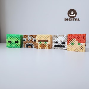May include: Five pixelated character cubes in green, brown, tan, gray, and red, each with distinct facial features. The word "DIGITAL" is printed below a download icon. These are likely handmade crafts or digital designs.