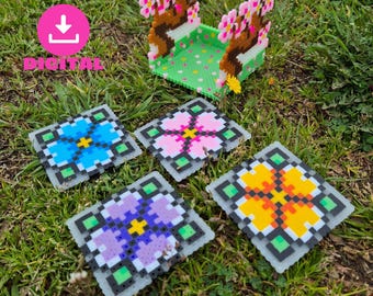 May include: Four colorful square coasters with floral designs. The coasters are made of plastic or ceramic and have a white background with green borders. The flowers are blue, pink, purple, and orange.