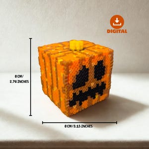 May include: A cube-shaped, orange and black pixel art pumpkin with a yellow stem. The pumpkin is 3.15 inches wide and 2.76 inches tall. The face has a carved-out design. The word "DIGITAL" is in the upper right corner.