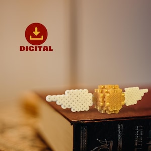 May include: A golden, cube-shaped object with white wings made of small, round beads, resting on a book. The word "DIGITAL" is displayed in red text with a download icon in a red circle.