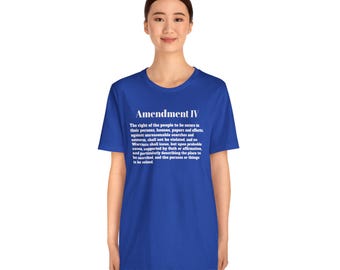 May include: A royal blue t-shirt with the text "Amendment IV" in white, followed by the text of the Fourth Amendment to the United States Constitution. The shirt is a short-sleeved crew neck.