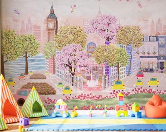 May include: A whimsical children's playroom featuring a colorful mural of a city scene with Big Ben. The room includes teepee tents, building blocks, and bean bag chairs. The color palette is soft, with pinks, greens, and yellows.