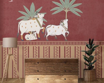 May include: A decorative wall mural featuring a traditional Indian design. The mural depicts white cows with brown spots, palm trees, and a red background. A wooden dresser and a floor lamp are in the foreground.