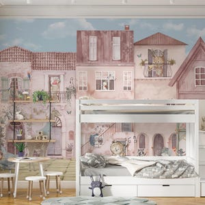 This wall mural is shown in a shared kids' bedroom featuring a white bunk bed and wooden shelving. The watercolor European cityscape serves as a peaceful backdrop, with the textured canvas material adding depth to the room's decor. The placement illustrates how the animal motifs remain visible around bedroom furniture.