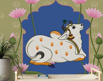 May include: A white cow illustration with orange and yellow accents, adorned with a peacock feather, rests against a blue backdrop. The artwork features pink lotus flowers and a green and gold patterned background, creating a serene and spiritual aesthetic.