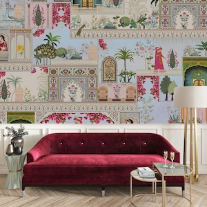 May include: A deep red velvet sofa sits before a wall covered in wallpaper featuring a collage of architectural elements, lush gardens, peacocks, and figures in traditional attire. A gold floor lamp and two small tables are placed nearby.