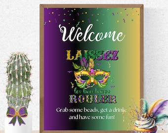 May include: A welcome sign for a Mardi Gras party with a purple, green, and gold gradient background. The sign features a gold mask with green and purple feathers and the text "Welcome Laissez les bon temps rouler. Grab some beads, get a drink, and have some fun!"