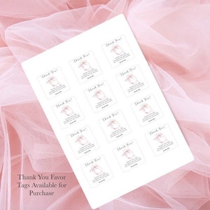 May include: A sheet of white paper with 16 square thank you favor tags. Each tag features a pink watercolor bow with the text "Thank You!" and a message thanking the recipient for celebrating with them on their special occasion. The text "Thank You Favor Tags Available for Purchase" is printed at the bottom of the sheet.