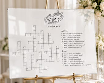 May include: A clear acrylic wedding sign featuring a black line art illustration of two connected heart-shaped lockets with the letters M and O. The sign displays a crossword puzzle titled SIP & SOLVE with numbered clues for Across and Down.