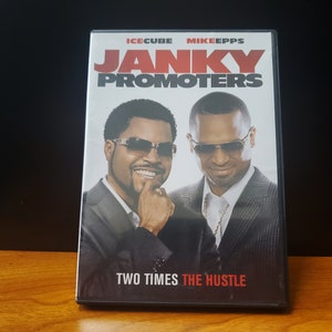 May include: DVD case for the movie "Janky Promoters" starring Ice Cube and Mike Epps. The case features a red and black design with the movie title and the tagline "Two Times The Hustle".