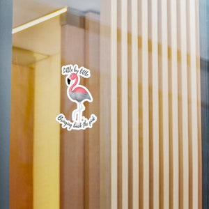 May include: A sticker featuring a flamingo with pink and gray feathers, standing on one leg. The text "Little by little" is above the flamingo, and "Bringing back the pink" is below.
