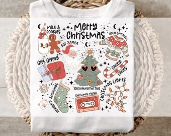 May include: White t-shirt with a colorful Christmas-themed graphic. The design includes a Christmas tree with sunglasses, Santa Claus, candy canes, and the words "Merry Christmas" and other holiday elements.