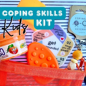 May include: An orange mesh bag containing a variety of items, including a container of peach-scented playdough, a keychain, and cards with coping skill prompts. The kit is labeled "COPING SKILLS Kids KIT".