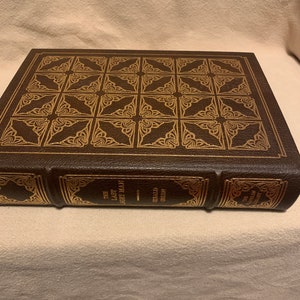 May include: A brown leather-bound book with gold embossed details on the cover. The title "The Last Man" is visible on the spine.