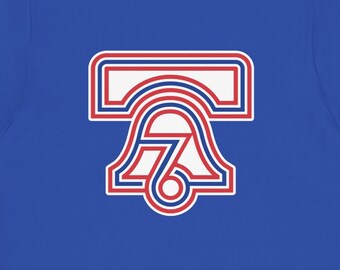 May include: A royal blue t-shirt with a red, white, and blue graphic of a Liberty Bell with the number 76 inside.