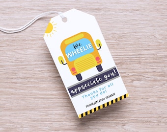 May include: A yellow school bus with the text "We Wheelie" and a black and yellow striped border. The text "appreciate you!" is written below the bus with the text "Thanks for all you do!" and "FROM JEN AND SAMMY" below that.