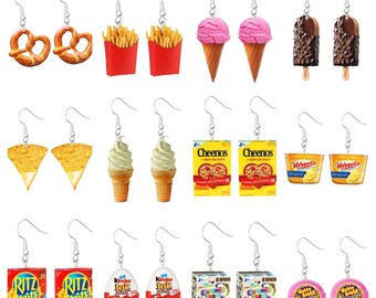 May include: A set of 12 pairs of dangle earrings featuring various food and snack items, including pretzels, french fries, ice cream cones, cereal boxes, and snack crackers. The earrings are silver-toned and have a variety of colors.