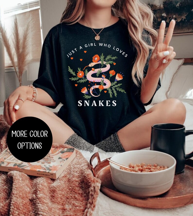May include: Black t-shirt with a graphic of a snake with flowers and the text "Just a girl who loves snakes".