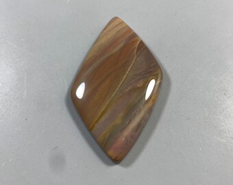 May include: A polished, diamond-shaped gemstone with a swirling pattern of brown, tan, and purple hues. The stone has a glossy finish and is likely used for jewelry or decorative purposes.