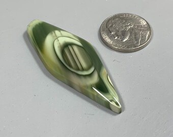 May include: A green, white, and brown agate cabochon with a diamond shape. The cabochon is about the size of a US quarter.