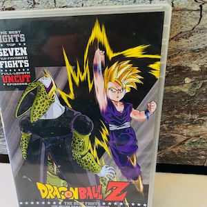May include: Dragon Ball Z DVD case featuring the text "The Best Fights - Top Seven Fan-Favorite Fights - Full-Length Uncut Episodes". The cover art features a yellow and green character fighting a purple character with a yellow aura.